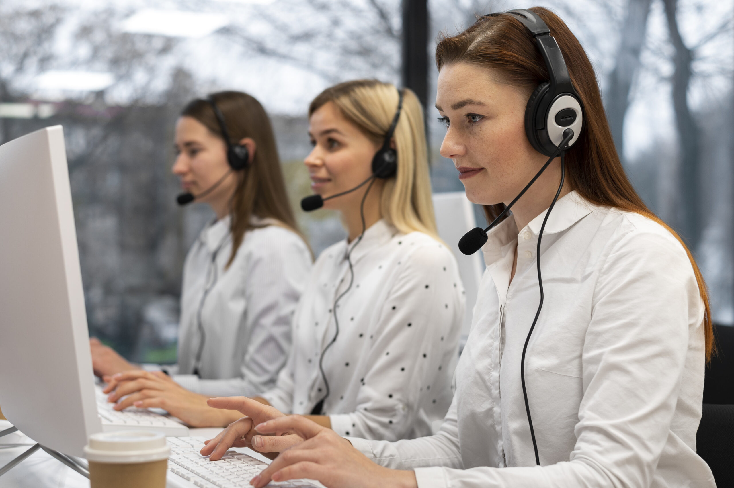 colleagues-working-together-call-center-with-headphones